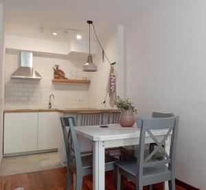 a kitchen with a table and chairs in a kitchen at El Canfranero in Canfranc-Estación