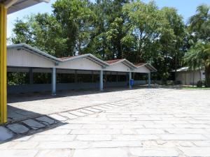 a large white building with trees in the background at Hotéis Pamplona in Rio do Sul