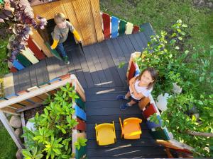 an overhead view of two children playing in a play house at Ferienhaus Strandstr 29 in Kolpinsee