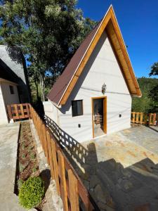 a small white building with a pitched roof at VILLA ITÁLIA CHALÉ in Santo Antônio do Pinhal