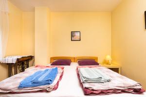 a bedroom with a bed with towels on it at Quiet apartment near the center in Plovdiv