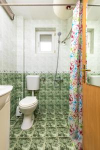 a bathroom with a toilet and a shower at Quiet apartment near the center in Plovdiv