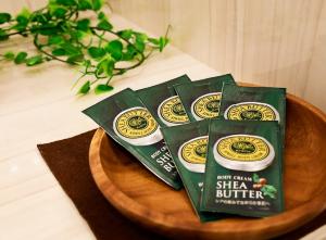three packs of sha butter on a wooden plate at Hotel Gran Villa in Tokyo
