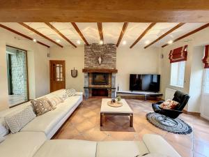 a living room with a couch and a fireplace at Au regard des biches in Sovet
