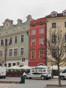 a white van parked in front of a building at 50 People Bis Apartment in Kraków