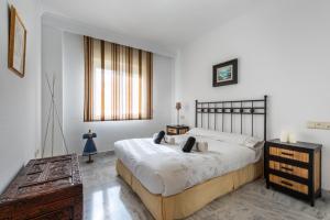 a bedroom with a large bed and a dresser at Apartamento Dama de Noche l in Marbella
