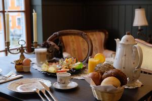 a table with a breakfast of eggs and food on it at Pilgrims Inn Kreischa in Kreischa