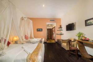 Postel nebo postele na pokoji v ubytování Marirath Boutique Hotel