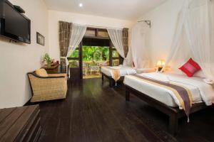 Postel nebo postele na pokoji v ubytování Marirath Boutique Hotel