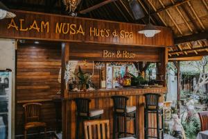 a bar with chairs in front of a restaurant at Alam Nusa Bungalow Huts & Spa in Nusa Lembongan +12 photos