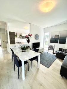 a living room with a white table and chairs at Your Familyapartment in Sirmione in Sirmione