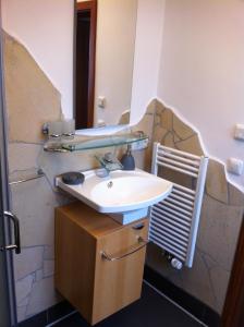 a bathroom with a sink and a mirror at Ferienwohnung Biermann in Oberammergau