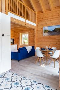 a living room with a blue couch and a table at Kranichglück in Pruchten