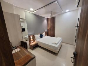 a small room with a bed and a desk at Hotel Heritage - Near Trade Center, Visa Consulate BKC in Mumbai