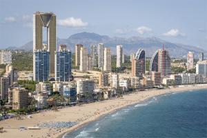 a city with a beach and buildings and the ocean at InTempo Luxury Sky View & Spa Resort in Benidorm