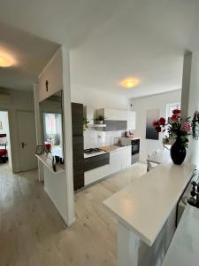 a large kitchen with white cabinets and a white table at Your Familyapartment in Sirmione in Sirmione