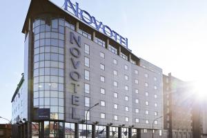 a building with a sign on the side of it at Novotel Paris 13 Porte d'Italie in Le Kremlin-Bicêtre