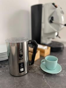a coffee pot sitting on a counter next to a cup at Lotelito Apartment in Fisciano