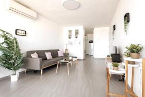 a living room with a couch and a table at Abbas BayView Apartment in Haifa