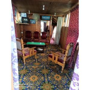 a room with chairs and a table in a train at House Boat Moti Mahal, Srinagar in Srinagar