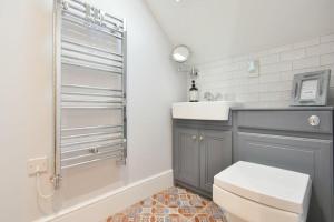 a bathroom with a toilet and a sink at Marmalade Cottage in Seahouses +42 photos