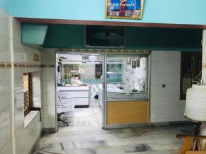 a kitchen with an open door in a room at Royal Rasool Residency in Paramagudi