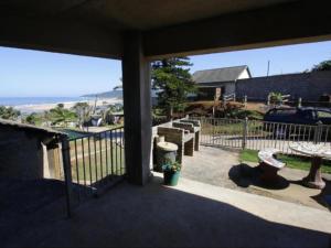 a patio with a view of the ocean from a house at Driftwood Chalets in Tugela Mouth