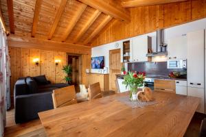 a kitchen and dining room with a wooden table at Apartment Grammlergut in Maria Alm am Steinernen Meer