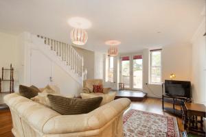 a living room with a couch and a tv at The Old Concert Room in Alnmouth