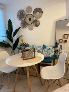 a dining room with a table and chairs and a couch at Cozy Studio Unit at Azure North San Fernando Pampanga in San Fernando