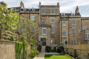 an old building with a yard in front of it at Dunsford House - Elegant Townhouse with Parking in Bath