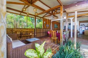 a living room with a table and chairs on a porch at Charisma Beach Resort in Siquijor