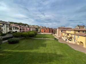 a green yard in a city with buildings at Apartment Claudia in Muggia