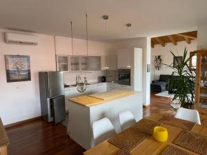 - une cuisine avec un réfrigérateur et une table dans la chambre dans l'établissement Apartment Claudia, à Muggia
