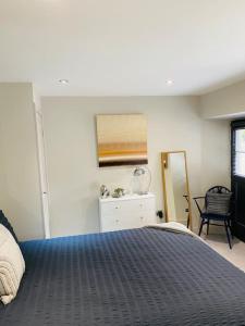 1 dormitorio con cama, tocador y espejo en Contemporary Luxury Barn Conversion in County Durham en Durham