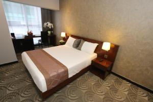 a hotel room with a bed and a desk at Metrostar Hotel Kuala Lumpur in Kuala Lumpur