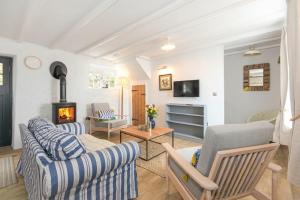 a living room with a couch and a fireplace at Seal Cottage in Burnmouth