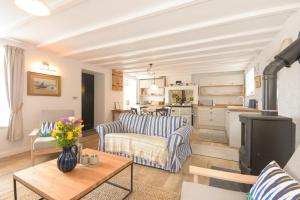 a living room with a couch and a table at Seal Cottage in Burnmouth