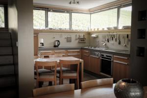 a kitchen with a table and two chairs and a sink at Gästehaus im Weingut am Stein in Würzburg