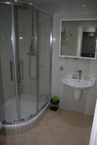 a bathroom with a shower and a sink at Marble Arch Flats in London