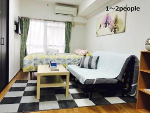 a small room with a bed and a table at Sun Heights Ikebukuro in Tokyo