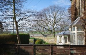 a wooden fence in front of a house at Beach House Alnmouth in Alnmouth