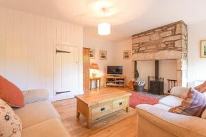 a living room with a couch and a table at Dunlin Cottage in Bamburgh