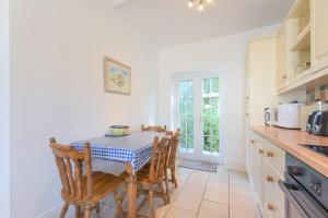a dining room with a table and chairs in a kitchen at Dunlin Cottage in Bamburgh