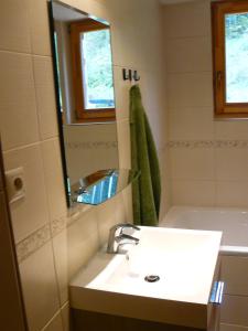 a bathroom with a sink and a mirror at Horáreň pod Dobákom in Lazisko