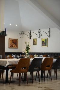 a dining room with a long table and chairs at Alexander Resort in Sopot