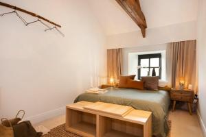 a bedroom with a bed and a table in it at The Bolthole in Eglingham