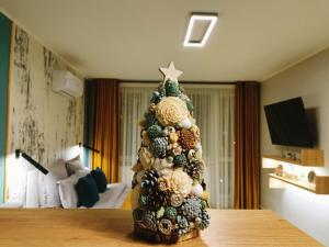 a christmas tree sitting on top of a table at AAB Studio Central in Piatra Neamţ