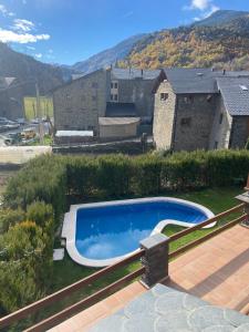 a swimming pool in the yard of a house at Casa Samarra in Vall de Cardos