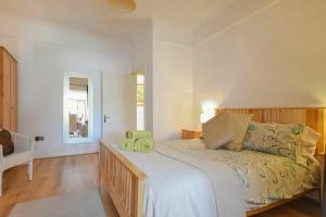 a bedroom with a large bed with green pillows on it at Alnbank in Alnmouth